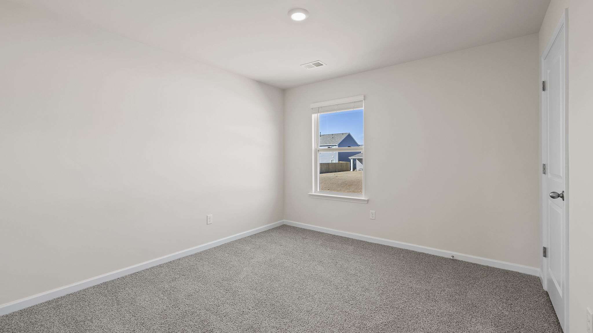 Bedroom with window and carpet.