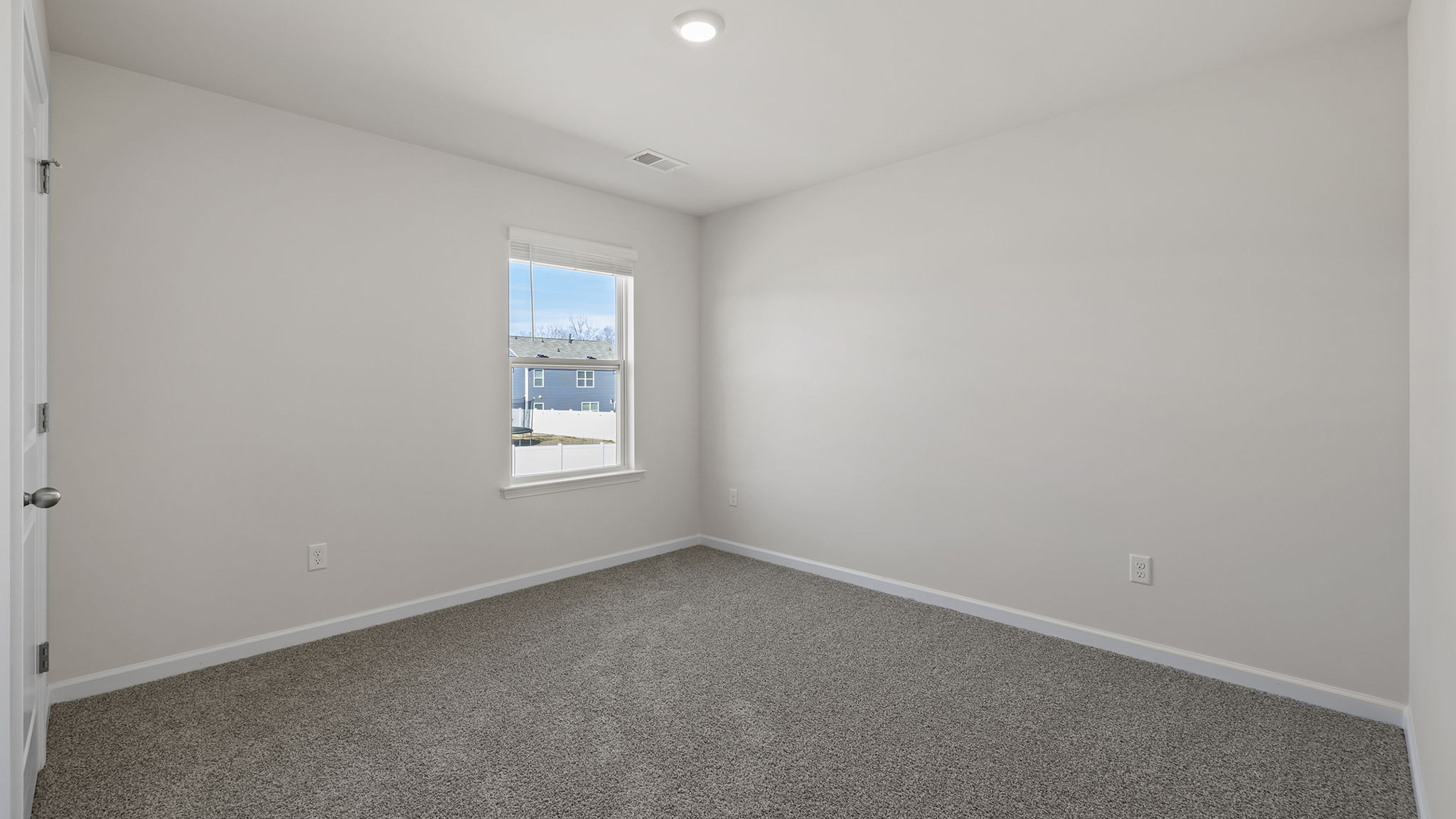 Bedroom with window and carpet.