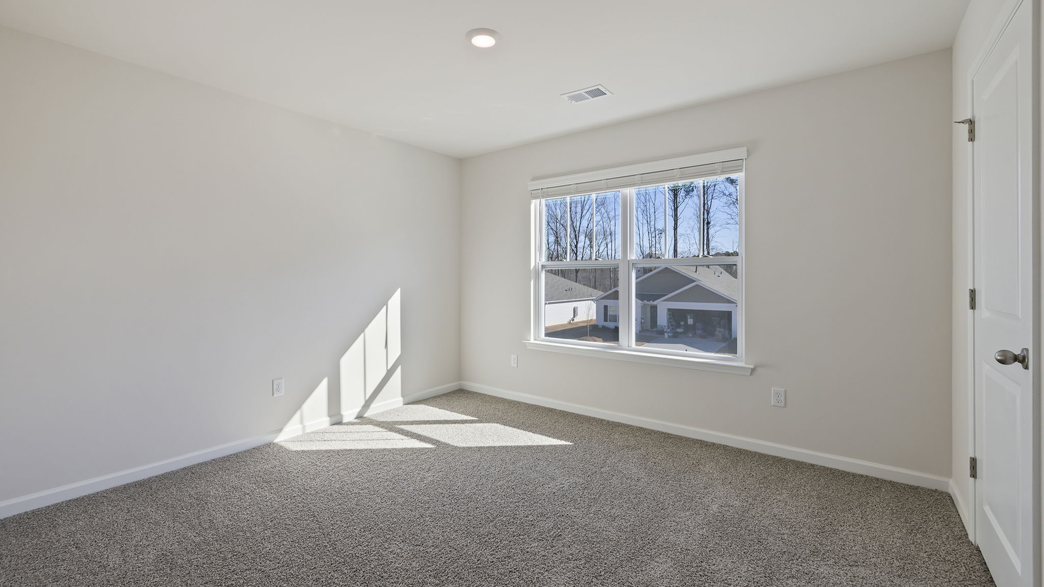 Bedroom with window and carpet.