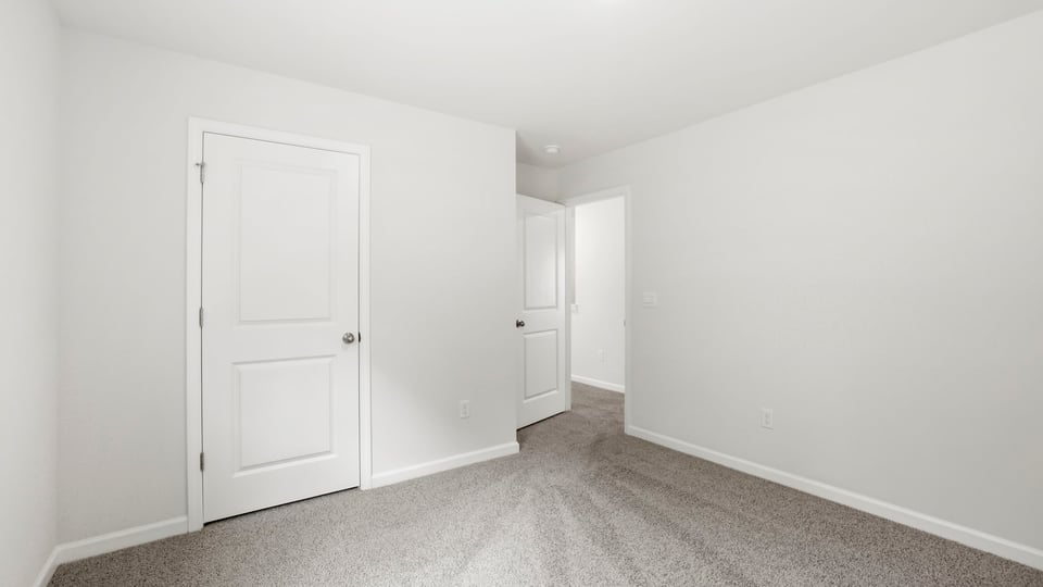 Bedroom with carpet and window.