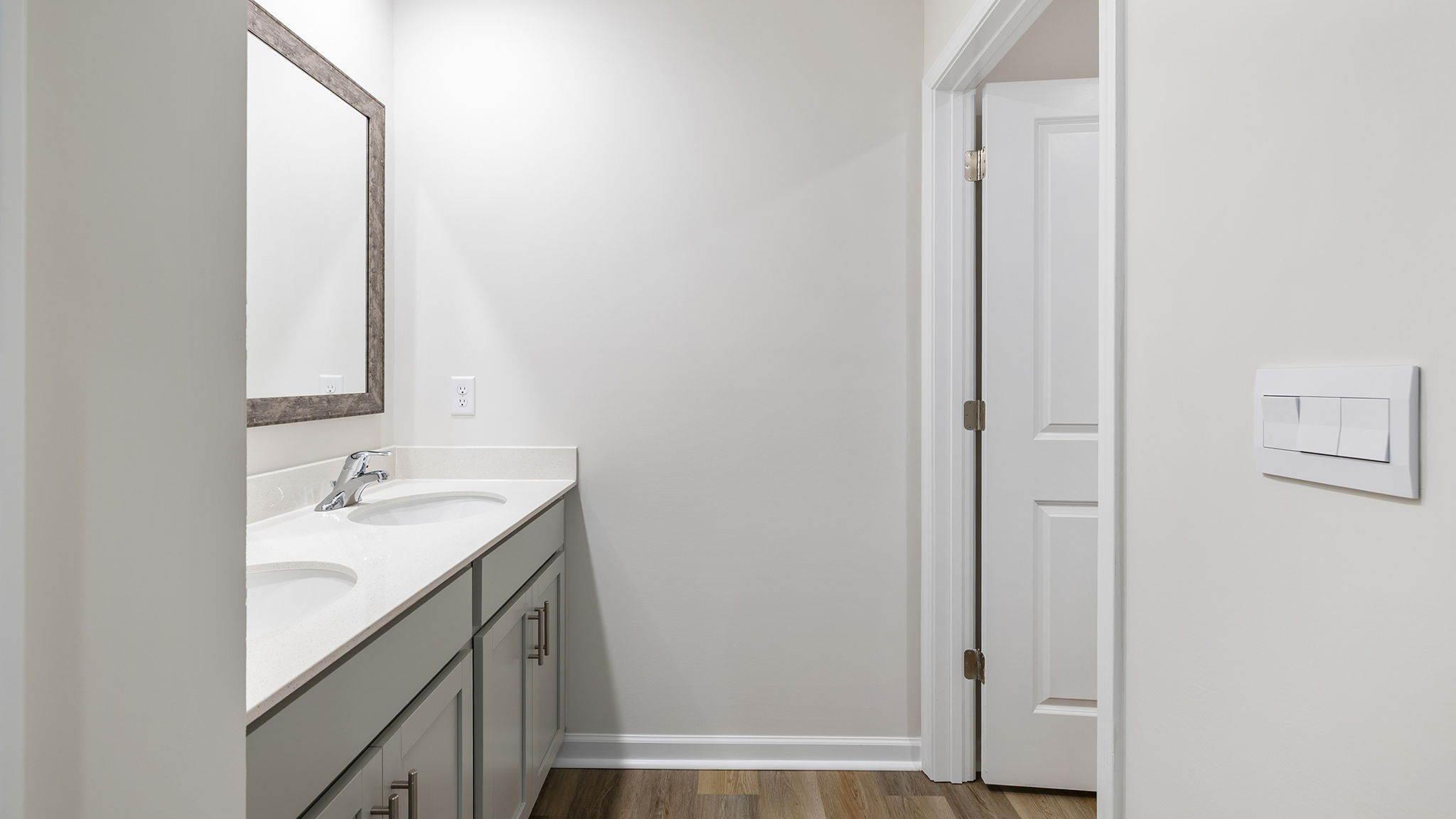 Hall bathroom with dual sink vanity.