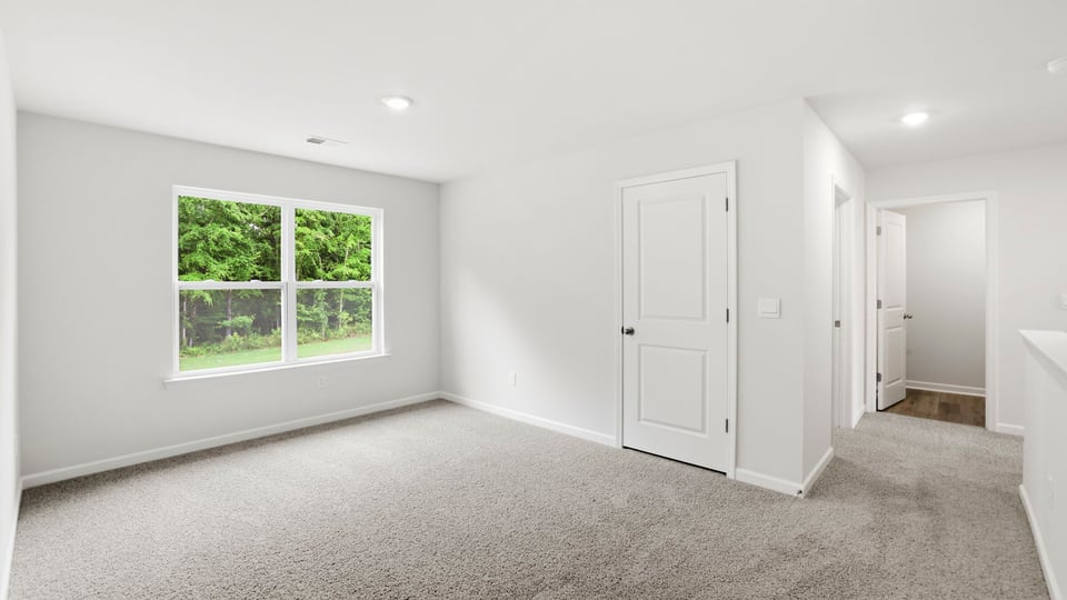 Bedroom with carpet and window.