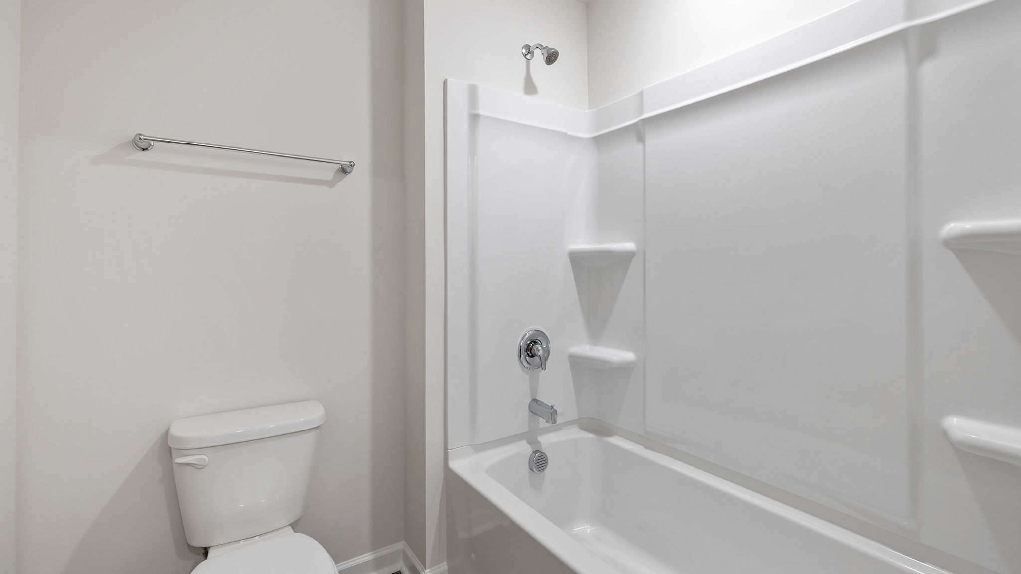 Hall bathroom separate shower and toilet area.