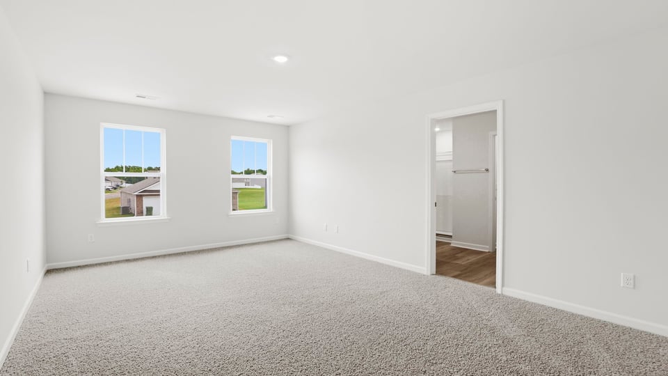 Bedroom with carpet and window.