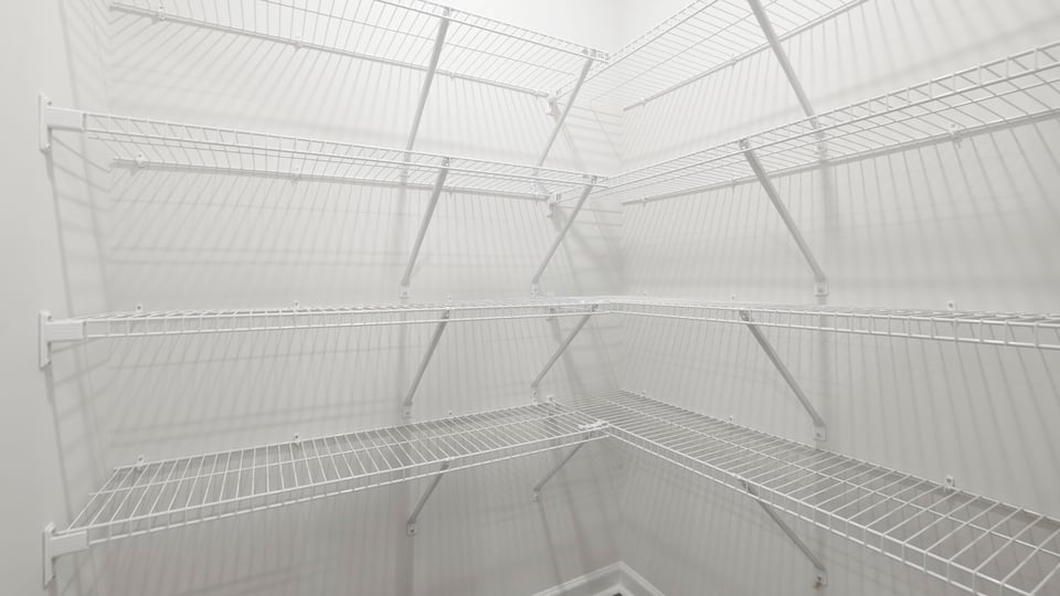 Closet with hanging storage racks.