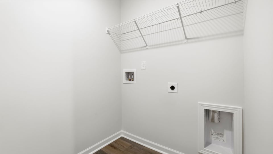 Laundry room with hanging storage racks.