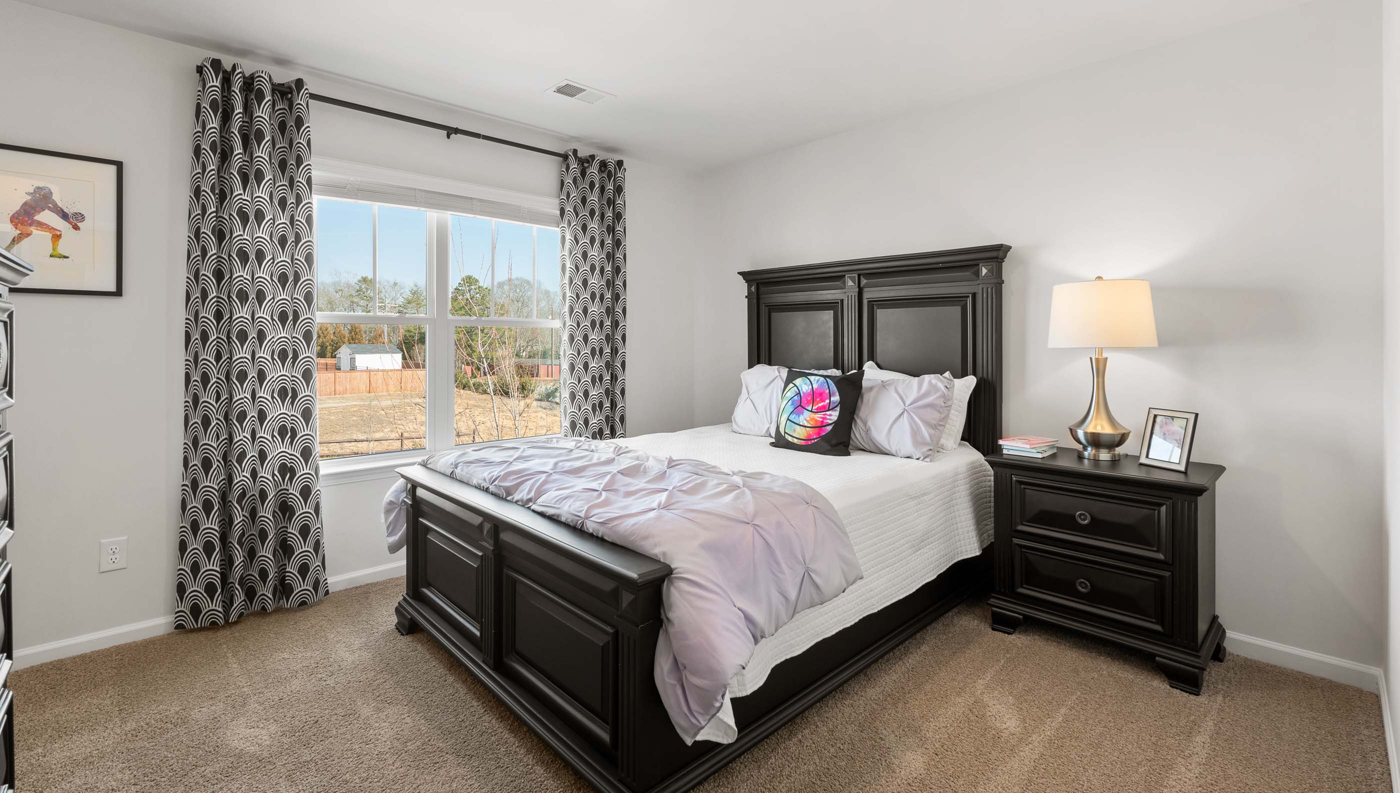 Bedroom with carpet and windows.