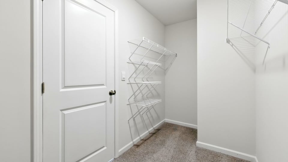 Primary closet with shelf.