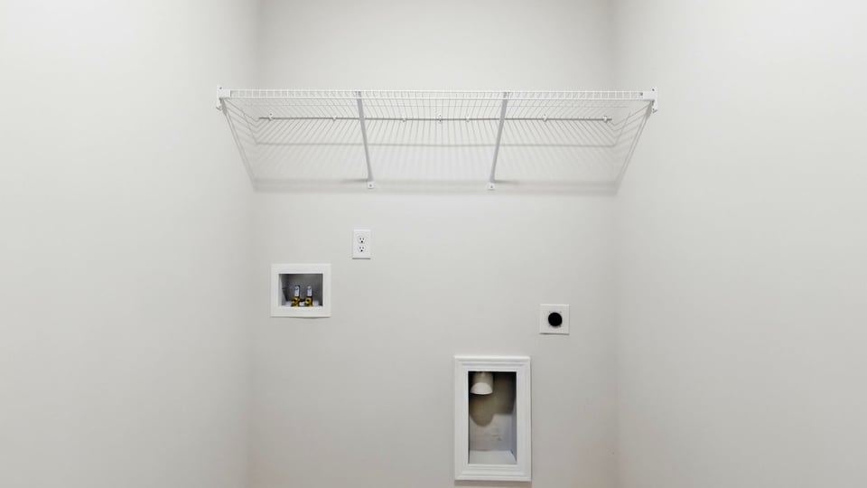 Laundry room with shelf.
