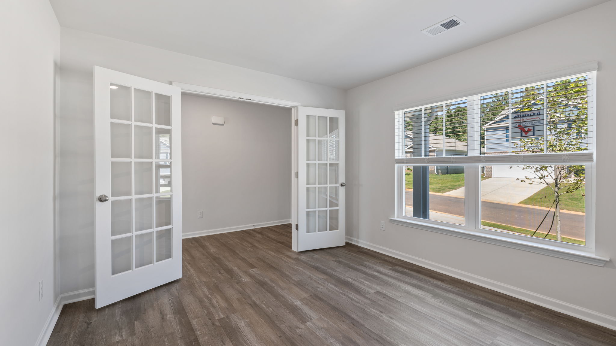 Study with windows and accented by French doors.