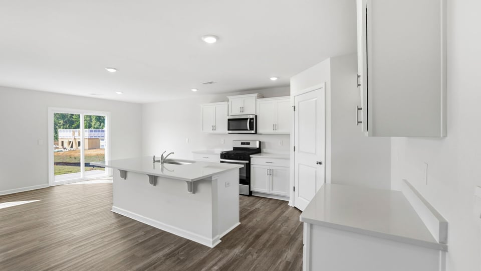 Kitchen and island with quartz countertops.