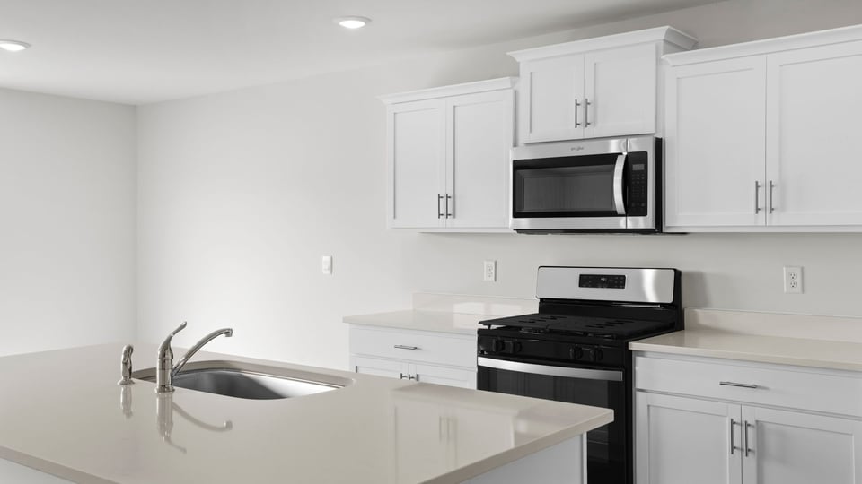 Kitchen and island with quartz countertops.