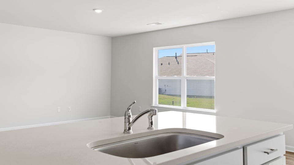 Kitchen and island with quartz countertops.