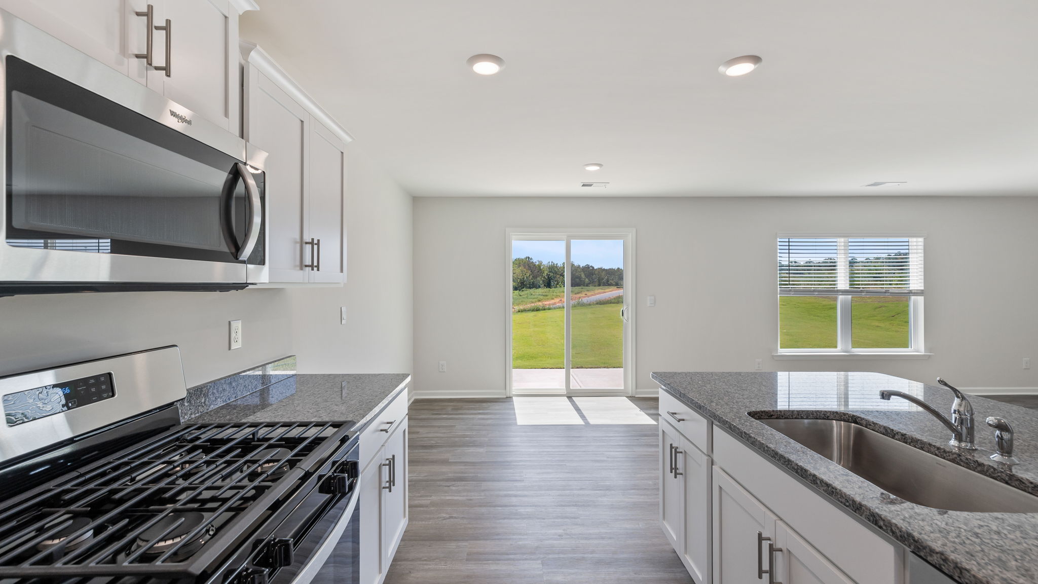 View of kitchen and dining area with door to the back yard.