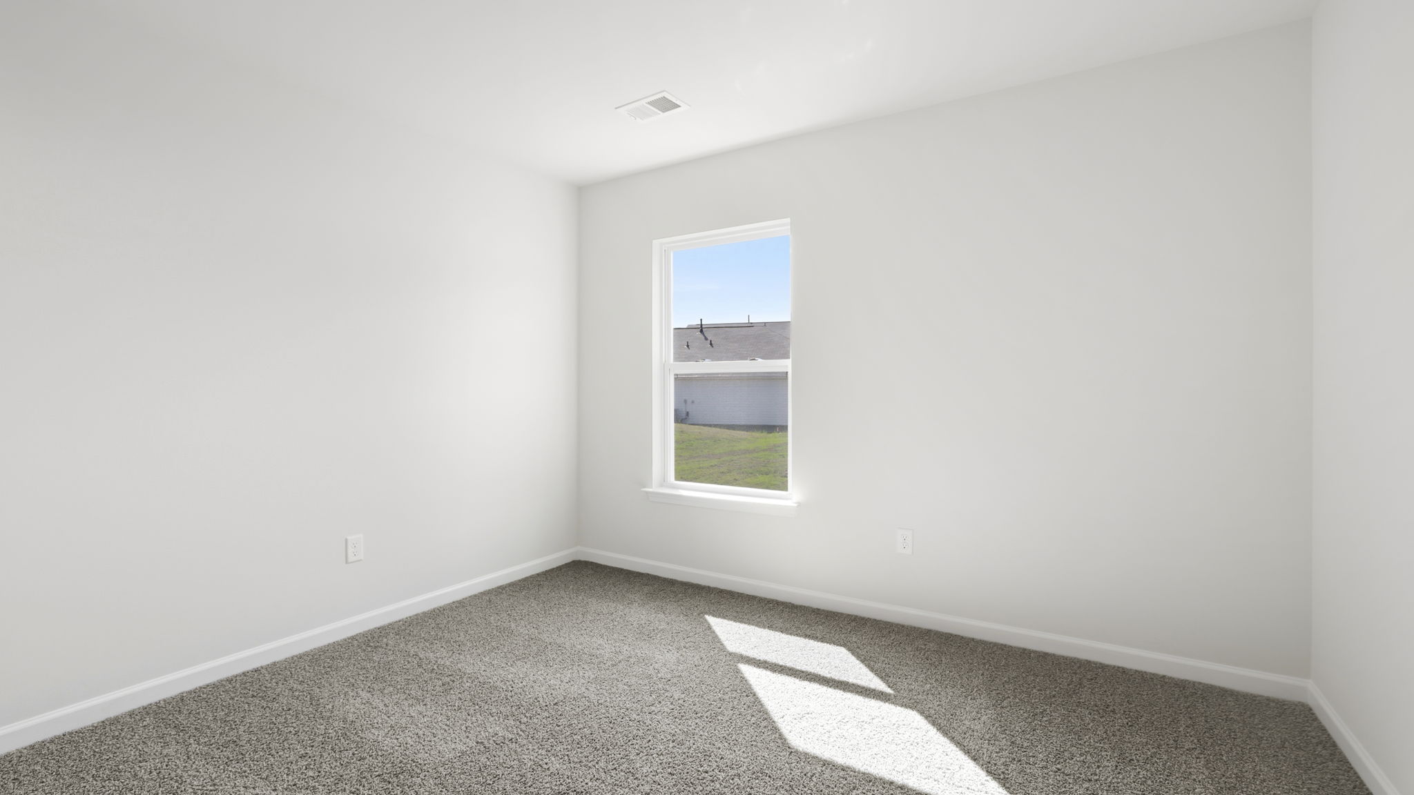 Bedroom with carpet and window.