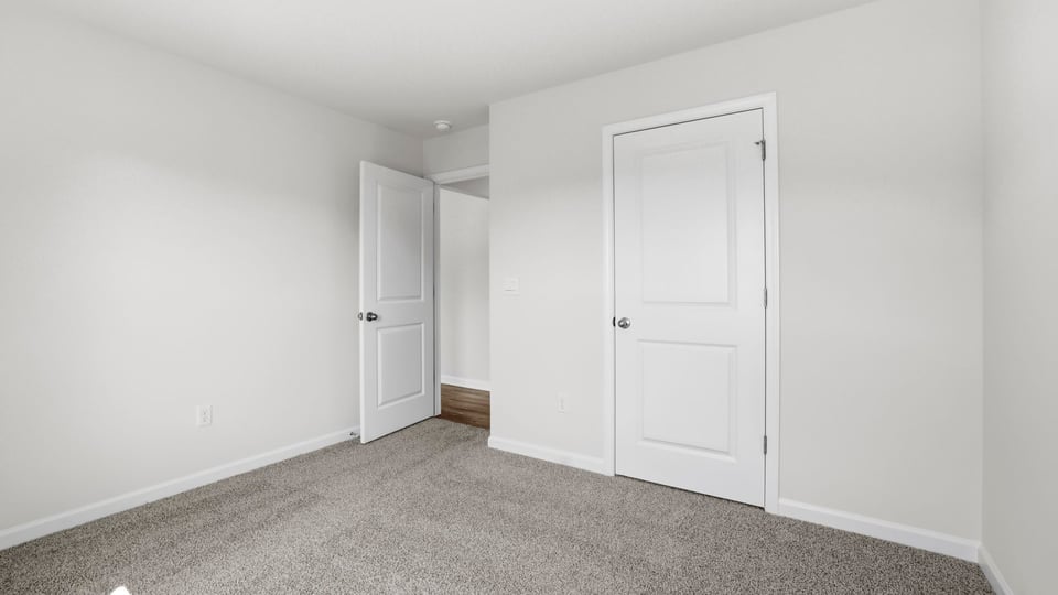 Bedroom with carpet and window.