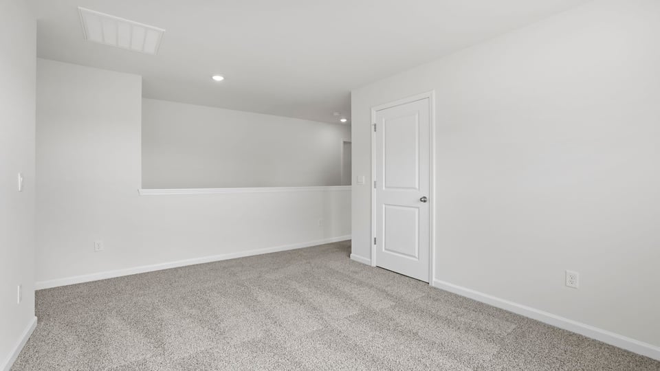Bedroom with carpet and window.