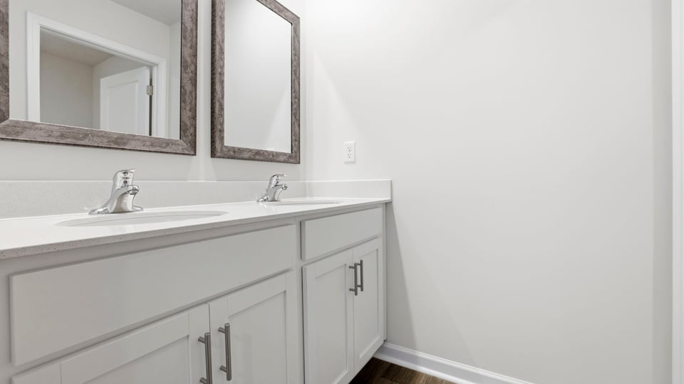 Bathroom with double vanity sink and tub.