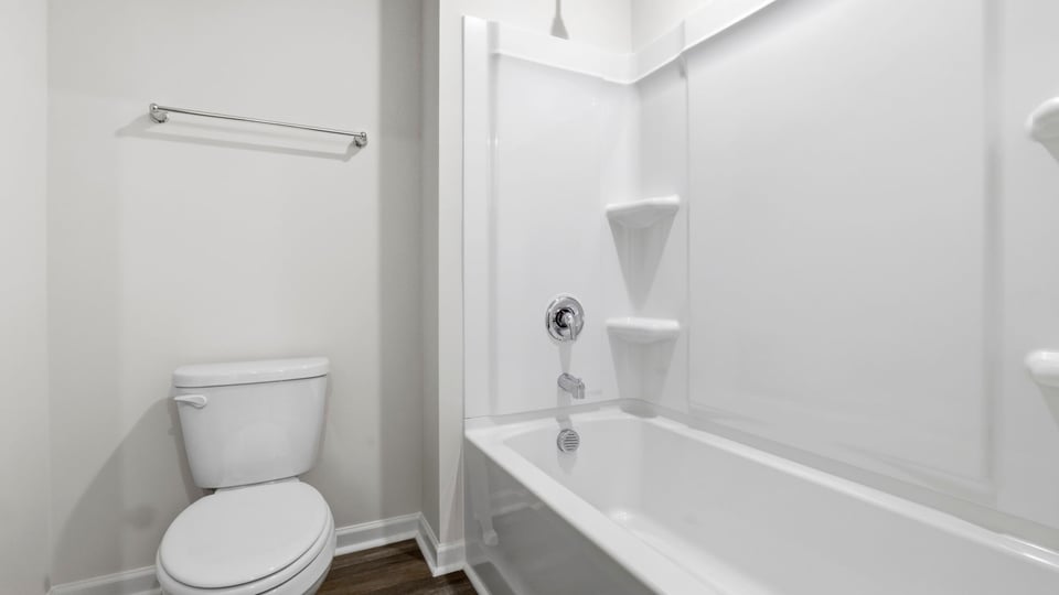 Bathroom with double vanity sink and tub.