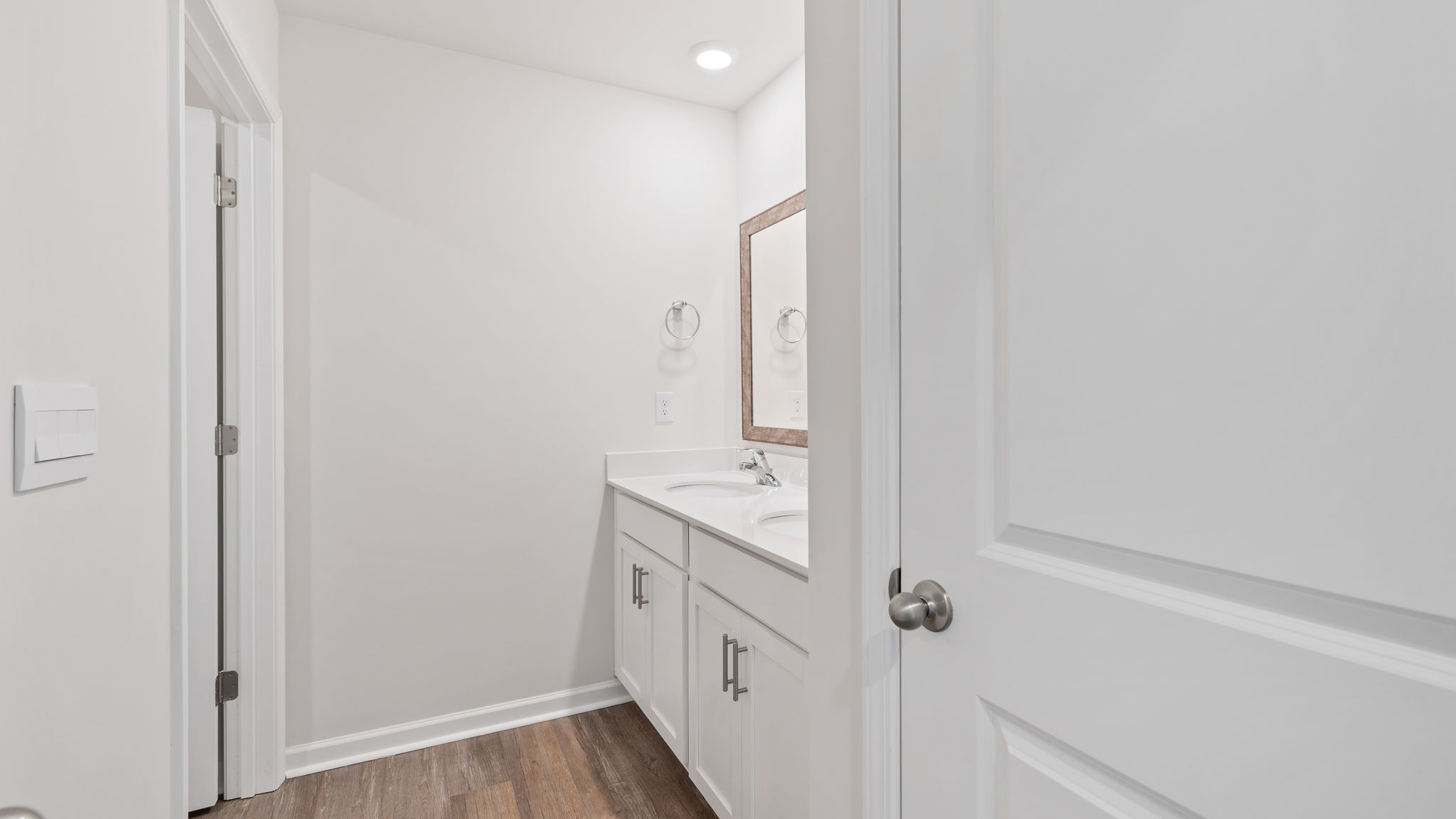Hall bathroom with vanity separate from shower area.