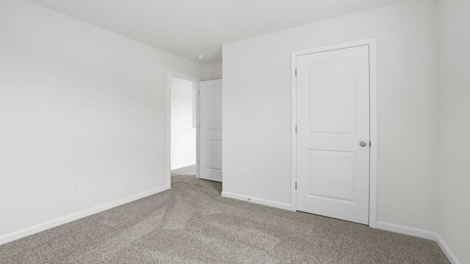 Bedroom with carpet and window.