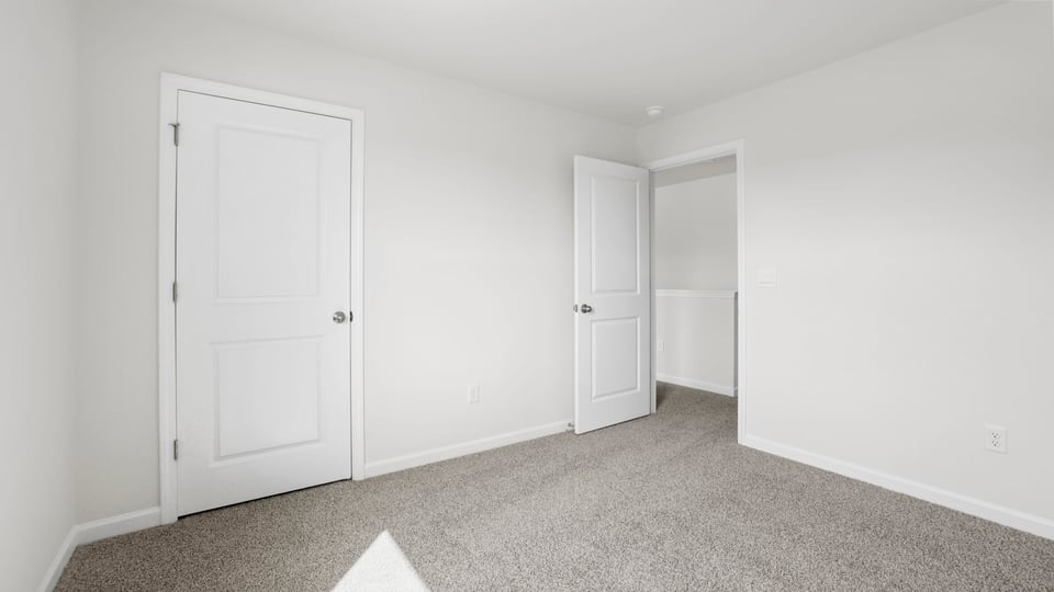 Bedroom with carpet and window.