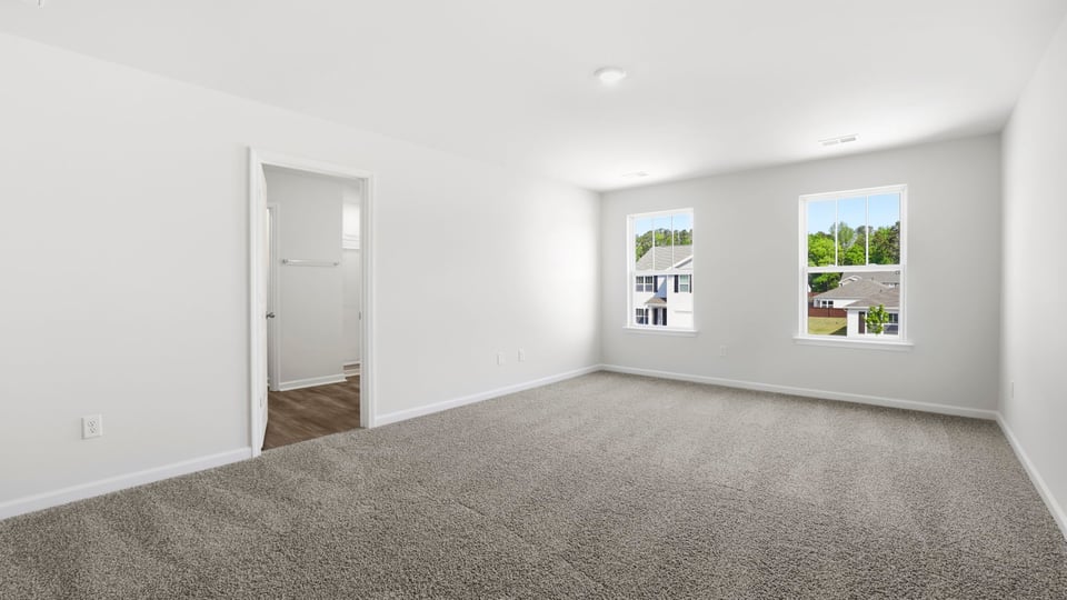 Bedroom with carpet and window.