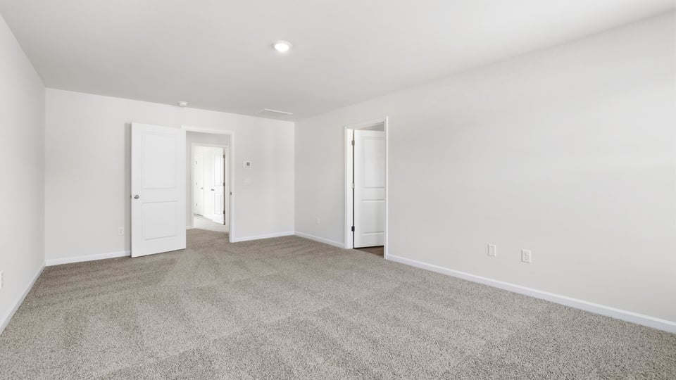 Bedroom with carpet and window.