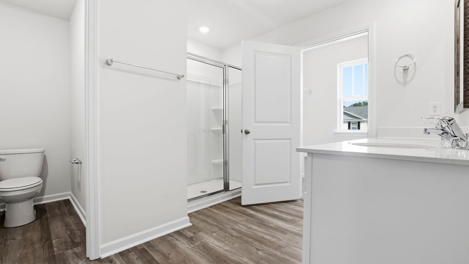 Bathroom with double vanity sink and walk in shower.