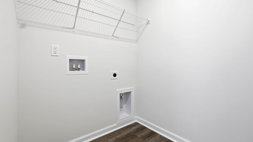 Laundry room with hanging storage racks.