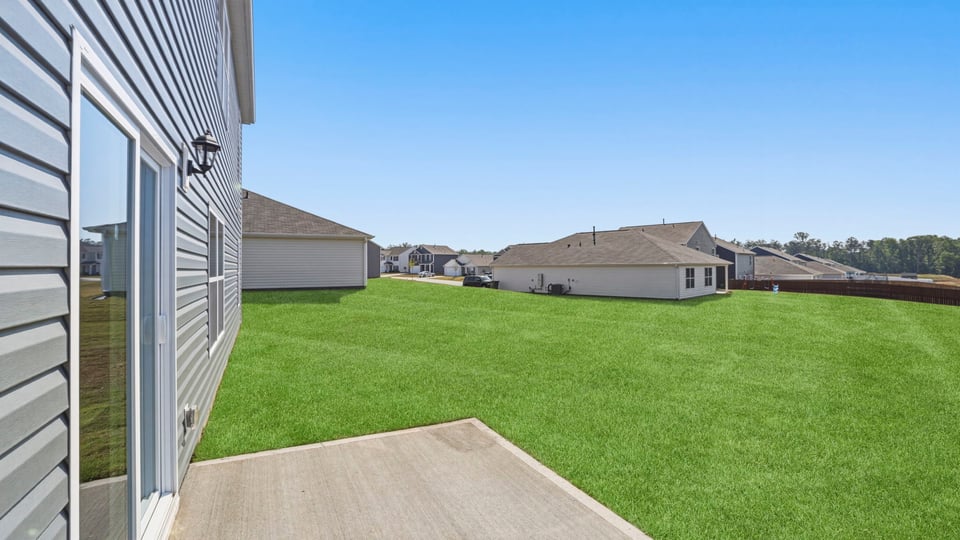 Back exterior of home with patio.
