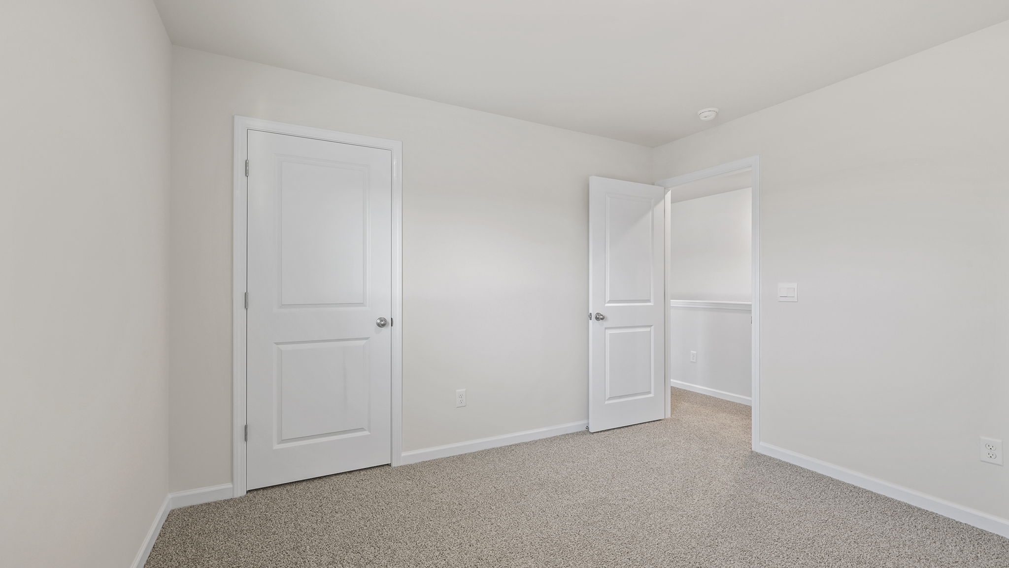 Bedroom with window and carpet.