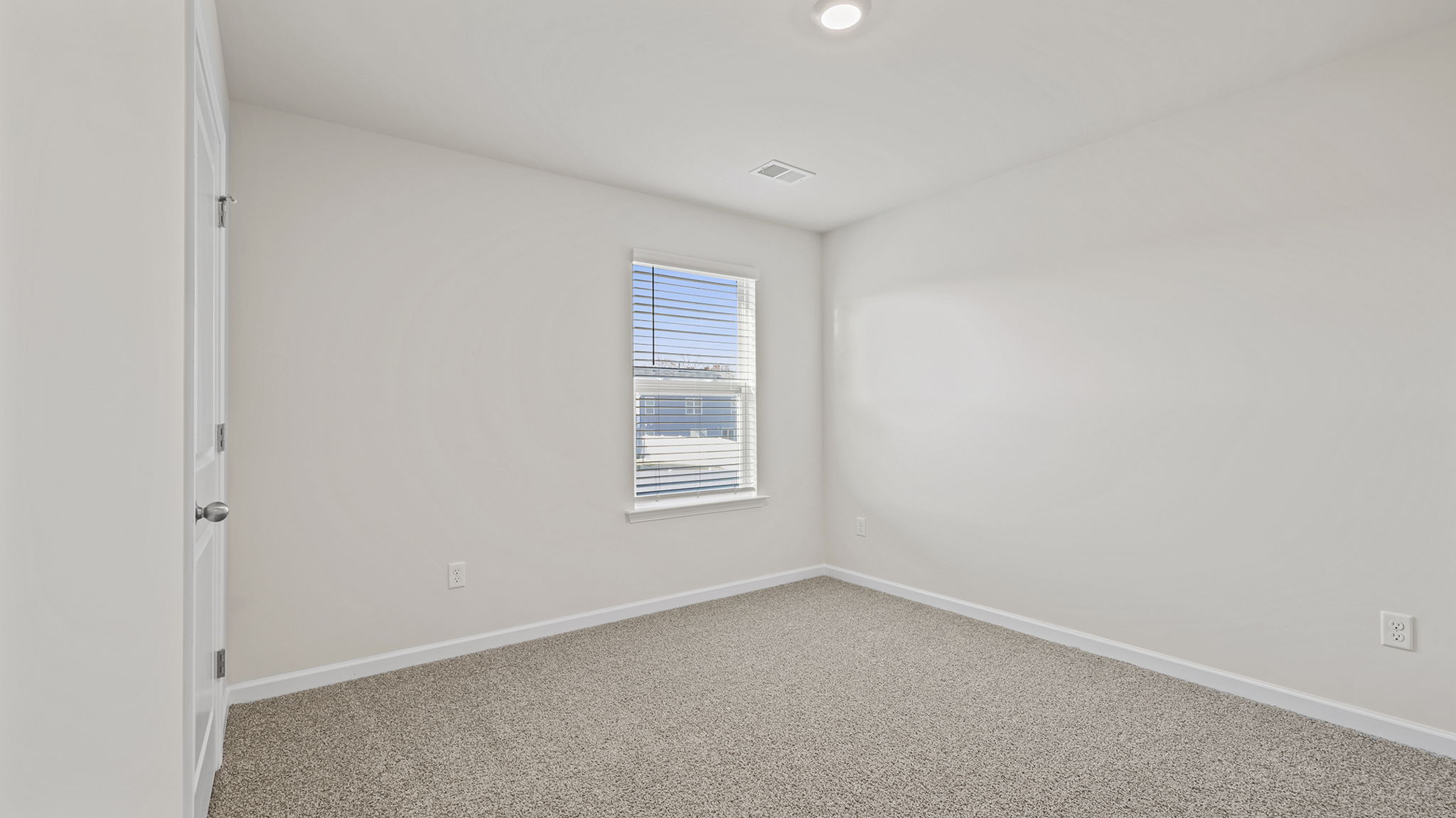 Bedroom with window and carpet.