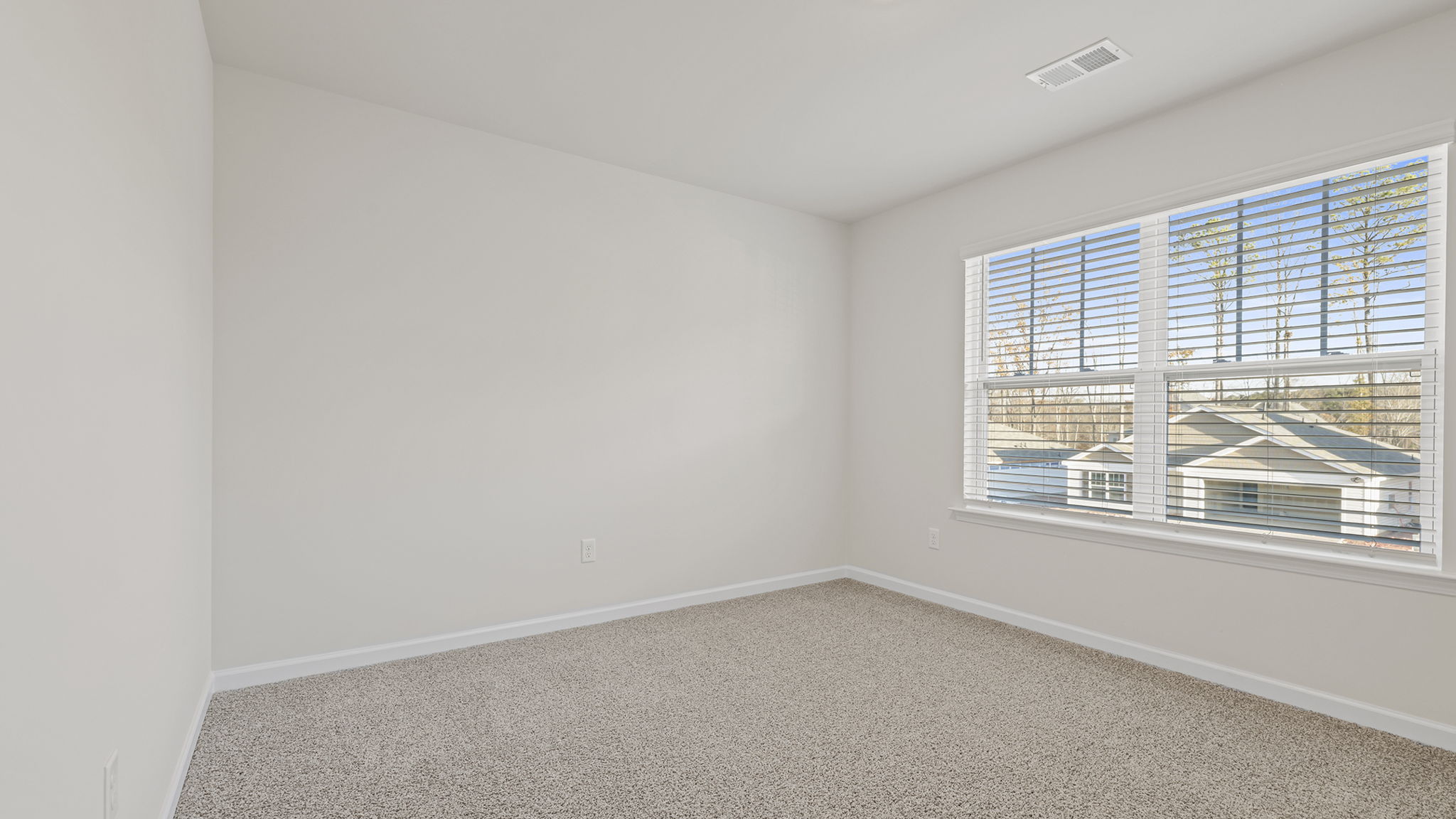 Bedroom with window and carpet.