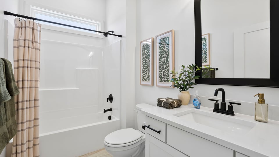 Bathroom with double vanity sink and shower.