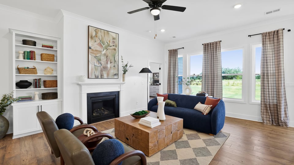Family room with large windows and fireplace.