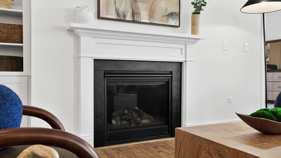 Family room with large windows and fireplace.