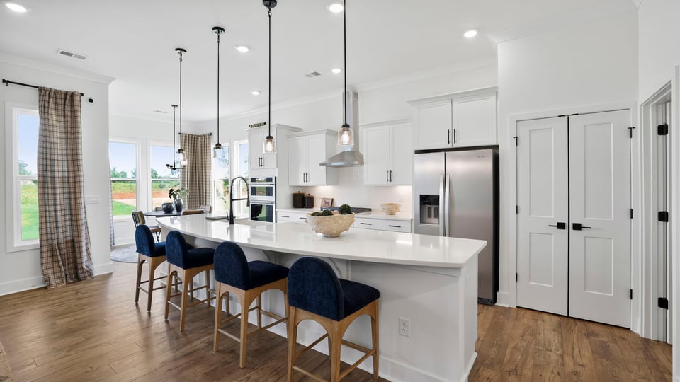 Kitchen island with quartz countertops and stainless steel appliances.