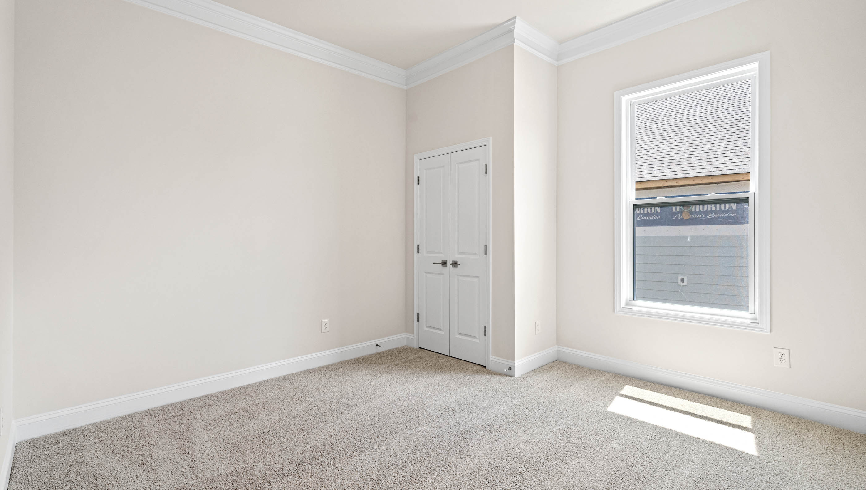 Bedroom with carpet and window.
