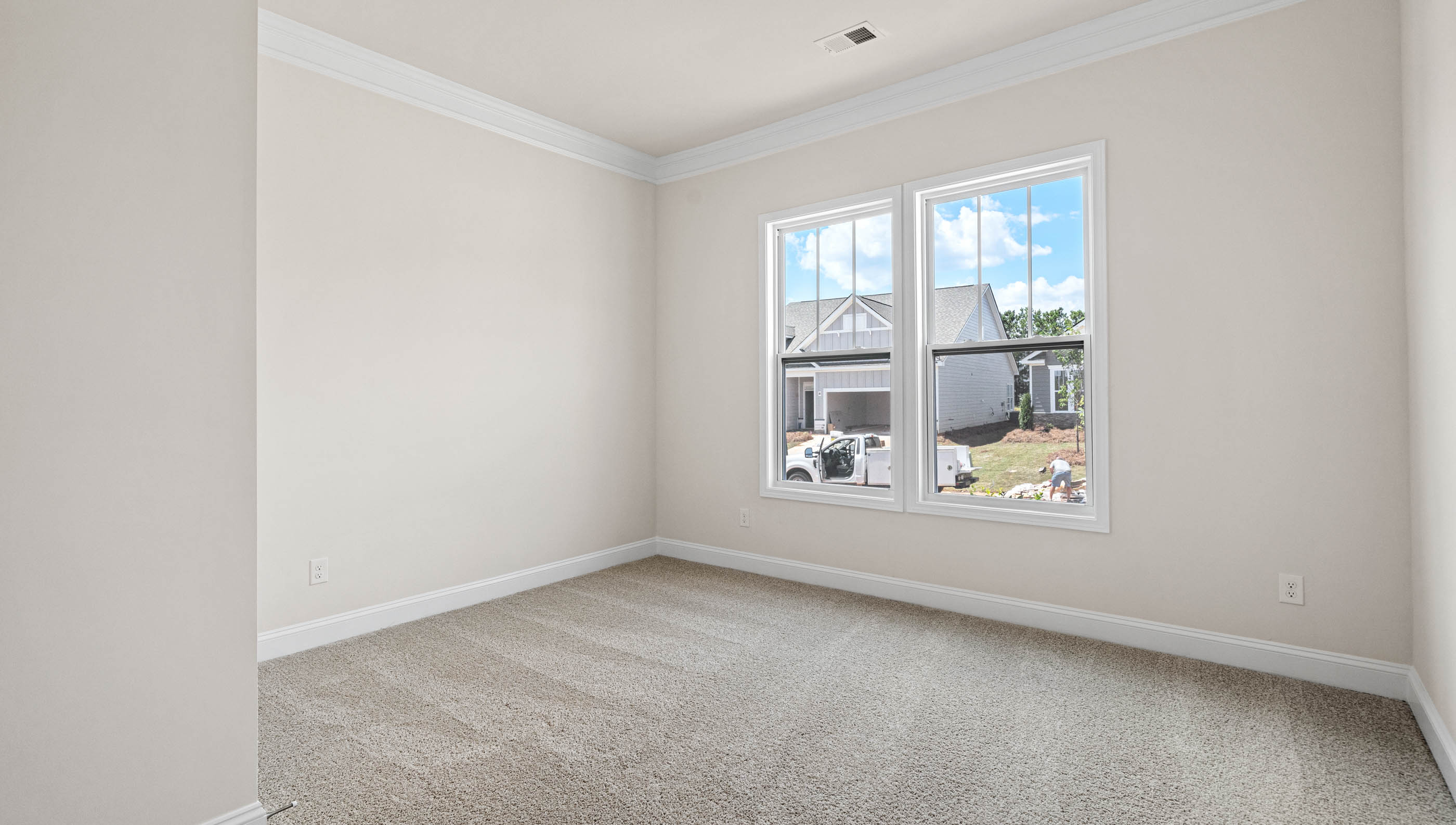 Bedroom with carpet and windows.
