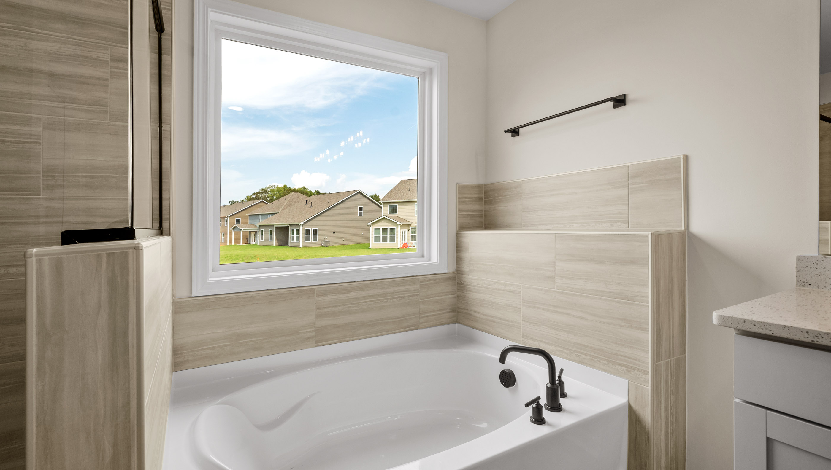 Bathroom with tub and window.