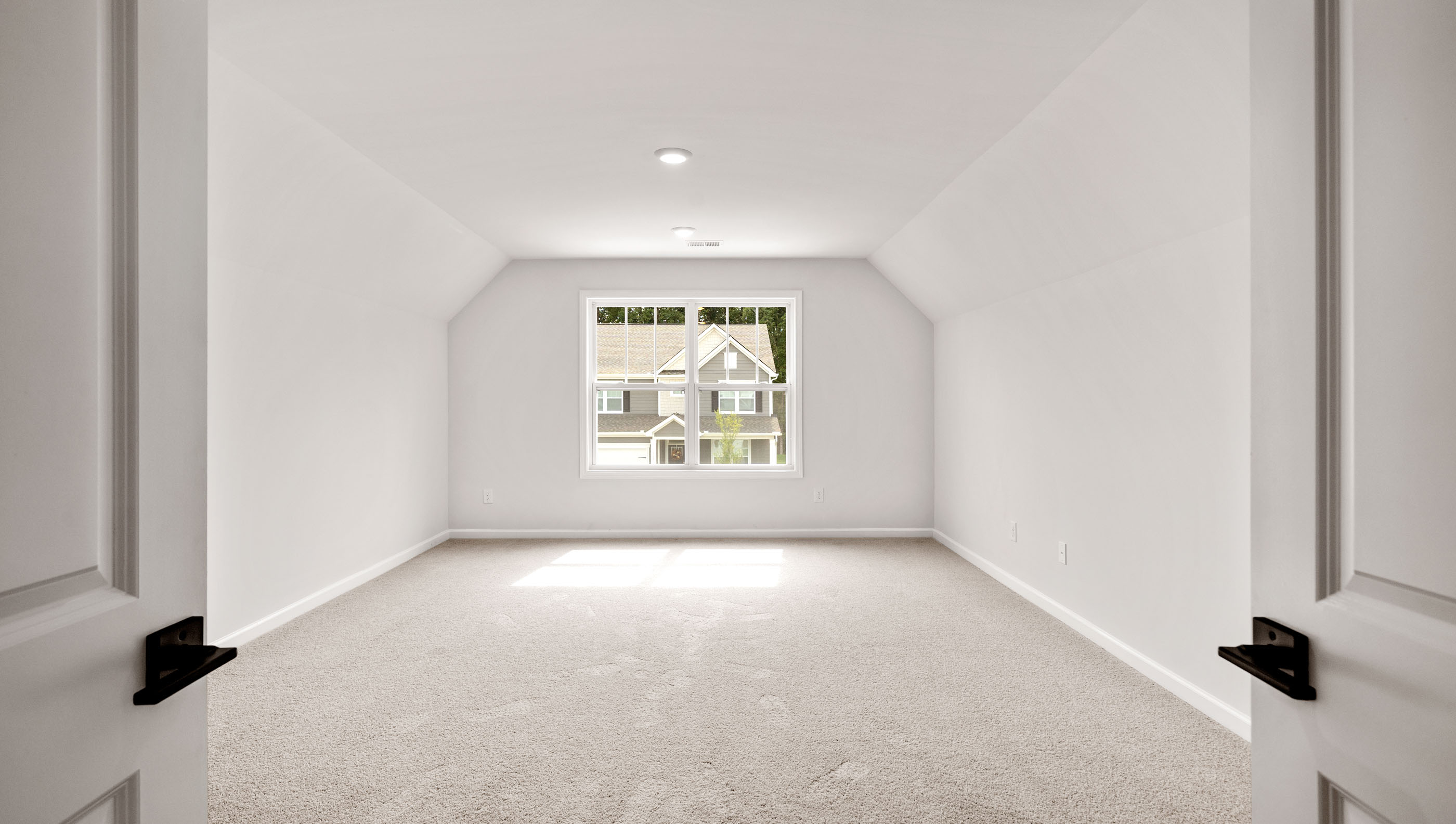 Bedroom with carpet and window.