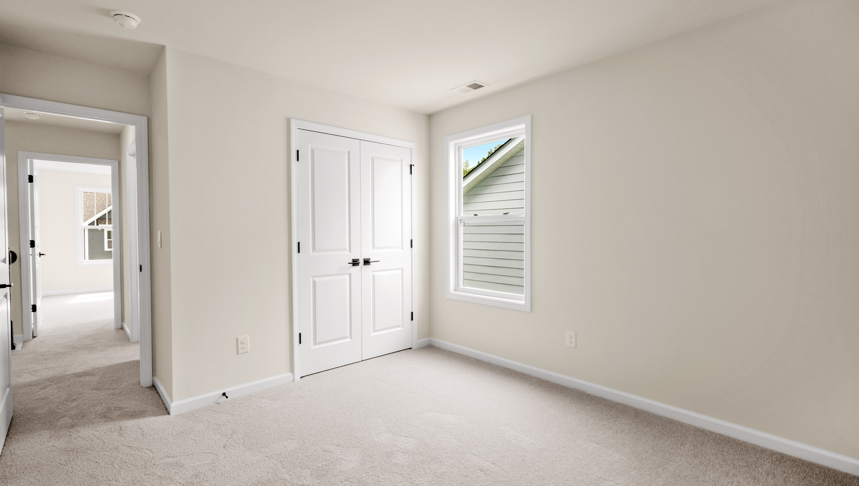 Bedroom with carpet and window.
