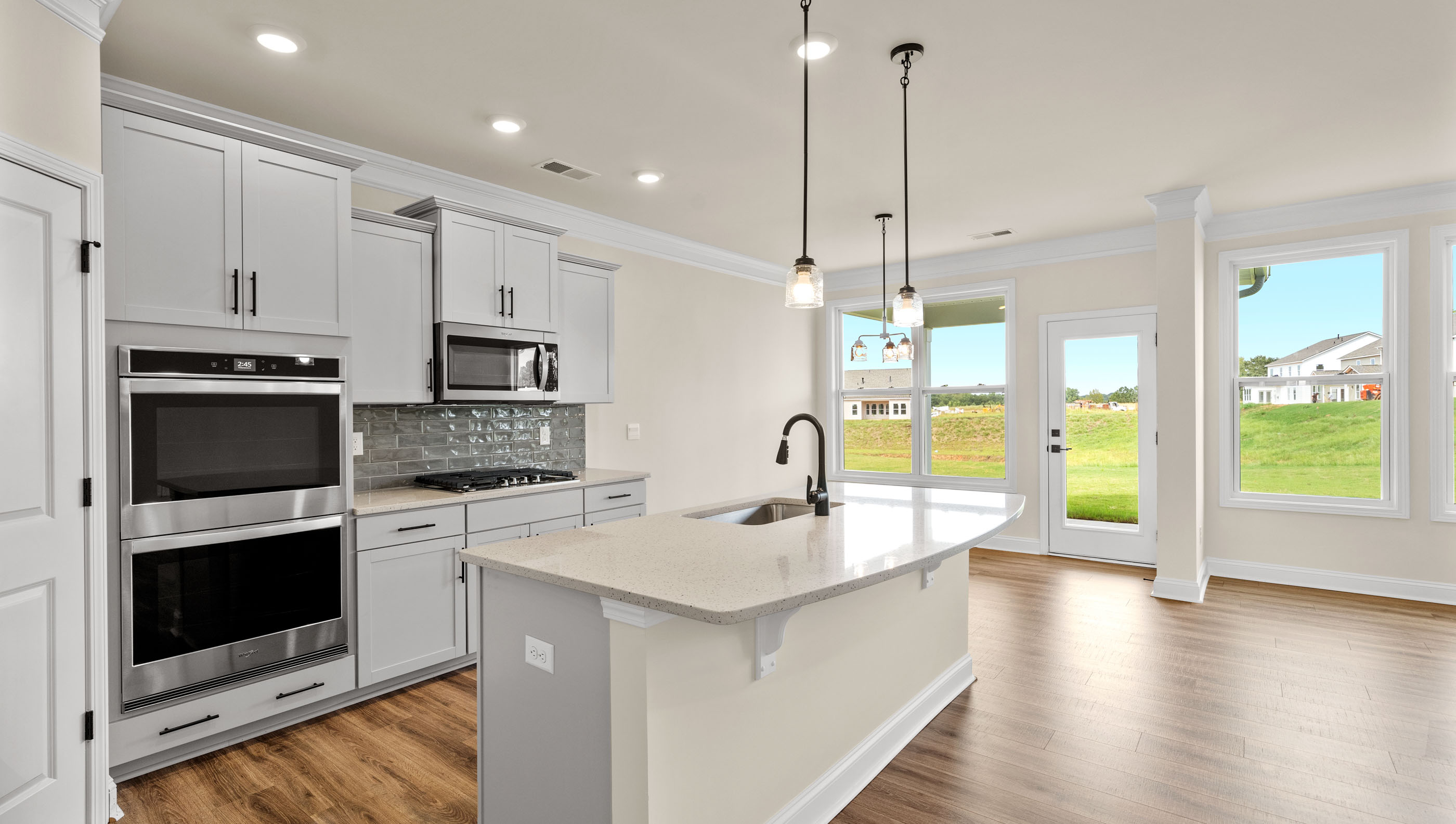 Kitchen with island with quartz.