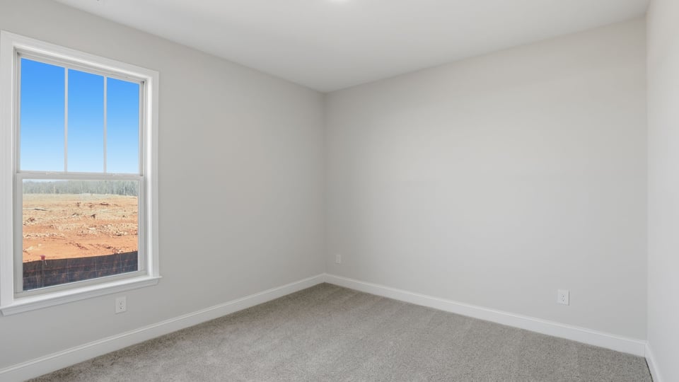 Bedroom with carpet and window.