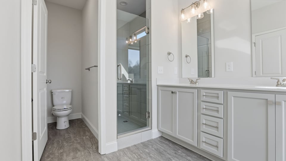 Bathroom with vanity and walk in shower.