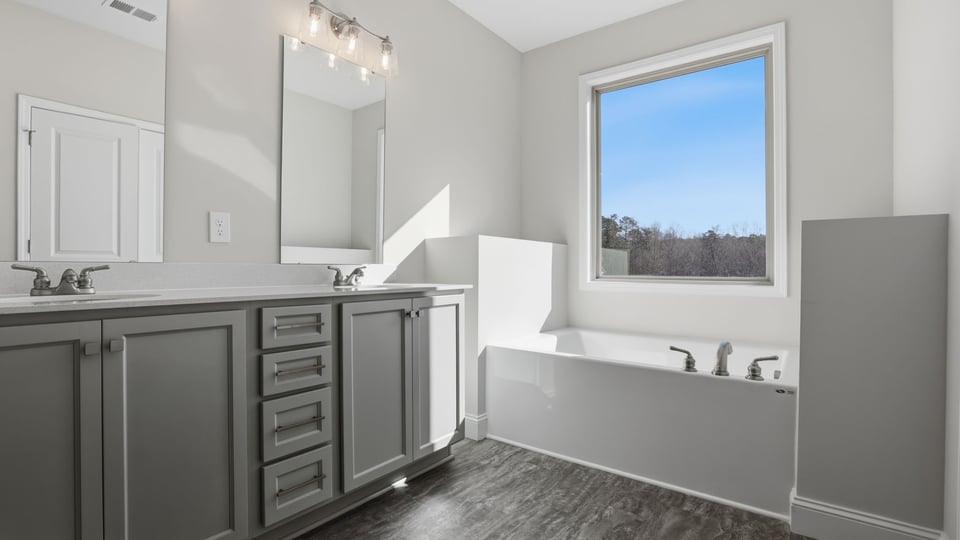 Bathroom with vanity and walk in shower.