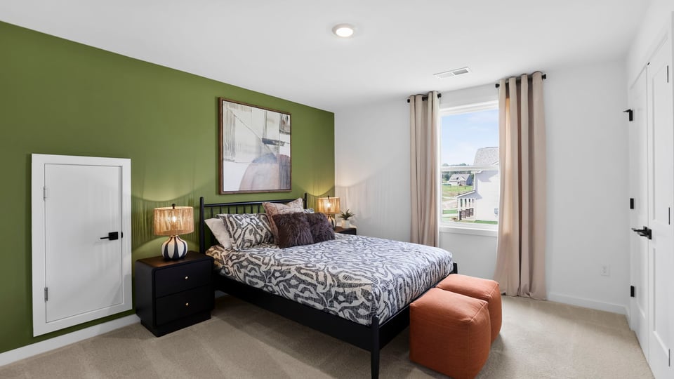 Bedroom upstairs with carpet and window.