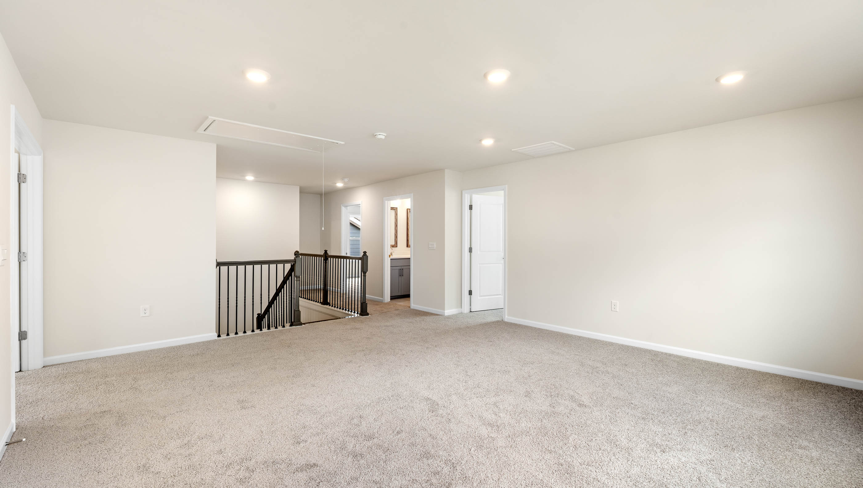 Bedroom with carpet and windows.