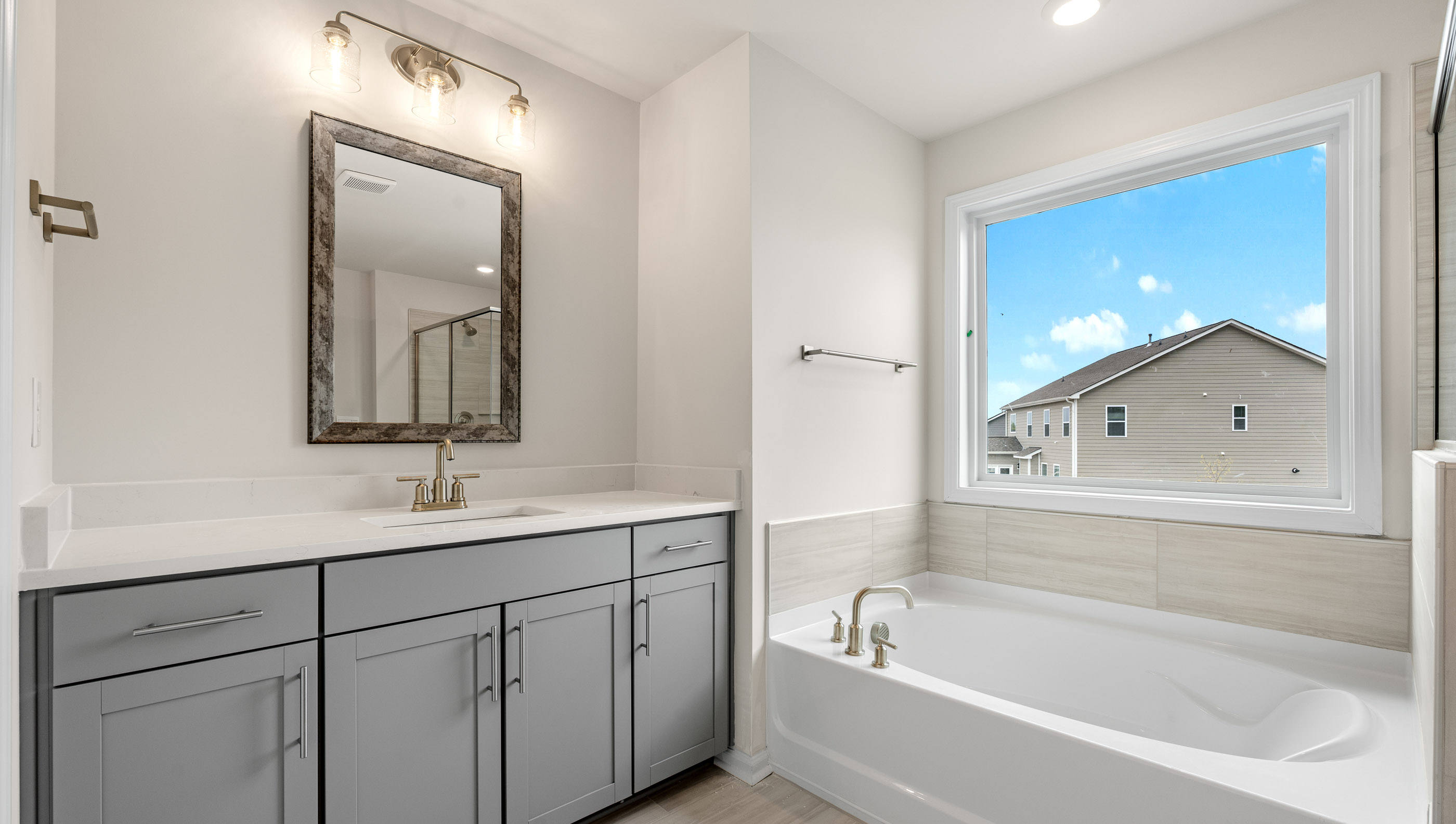 Bathroom with tub and walk in shower.